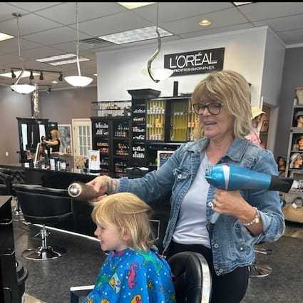 Portrait of Tracey McHugh, a professional stylist at Alluring Designs A Salon, showcasing their expertise and style.